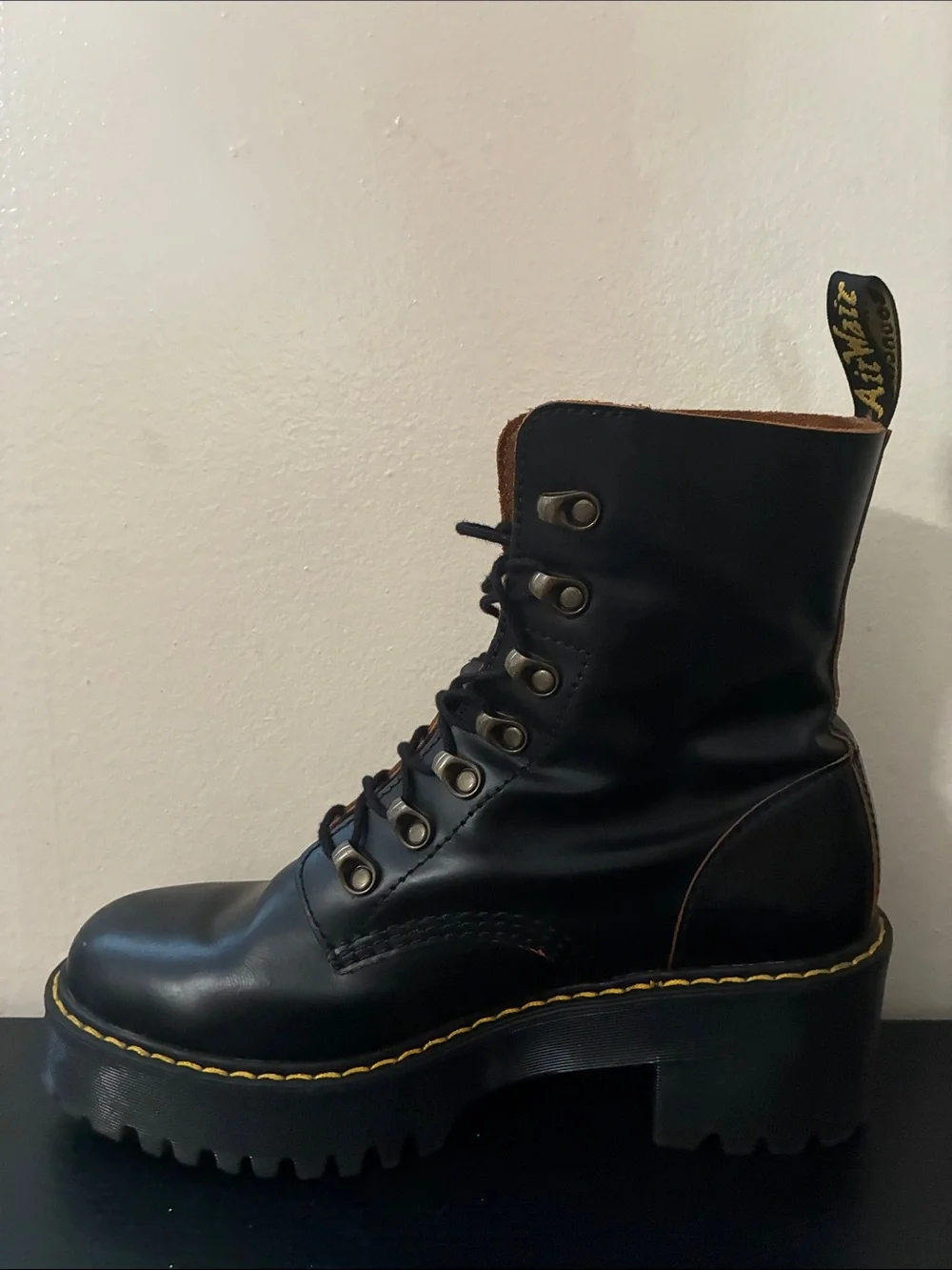 Dr. Martens Leona platform boots featuring a black smooth leather size 9